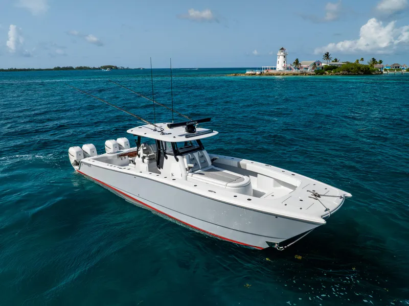 Slide: The Image of 2022 Freeman 37 VH boat cruising near a scenic lighthouse and tropical island. - 13