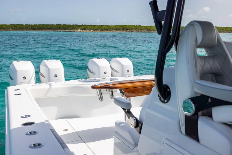 Slide: The Image of 2022 Freeman 37 VH boat with four Mercury engines on turquoise water. - 34
