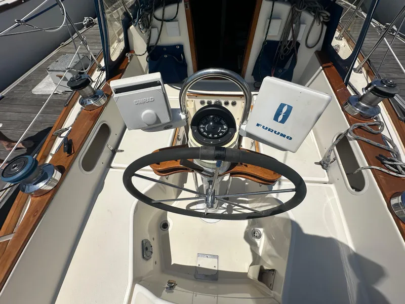 Slide: The Image of Cockpit of 1985 Sabre 34 MKI sailboat with steering wheel and navigation equipment. - 11