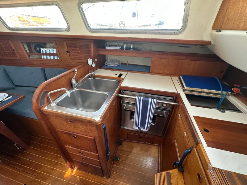 Slide: The Image of 1985 Sabre 34 MKI yacht interior with wooden cabinetry and dual sink. - 15