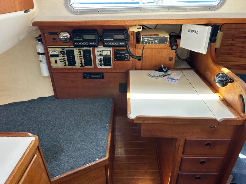 Slide: The Image of Navigation station of a 1985 Sabre 34 MKI sailboat with control panels and equipment. - 16