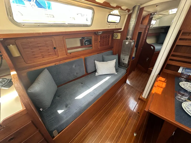 Slide: The Image of 1985 Sabre 34 MKI yacht interior with wooden finish and cozy seating area. - 18