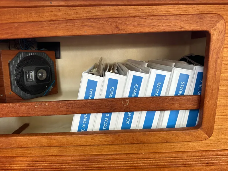 Slide: The Image of Wooden shelf with manuals and a speaker on a 1985 Sabre 34 MKI yacht. - 23