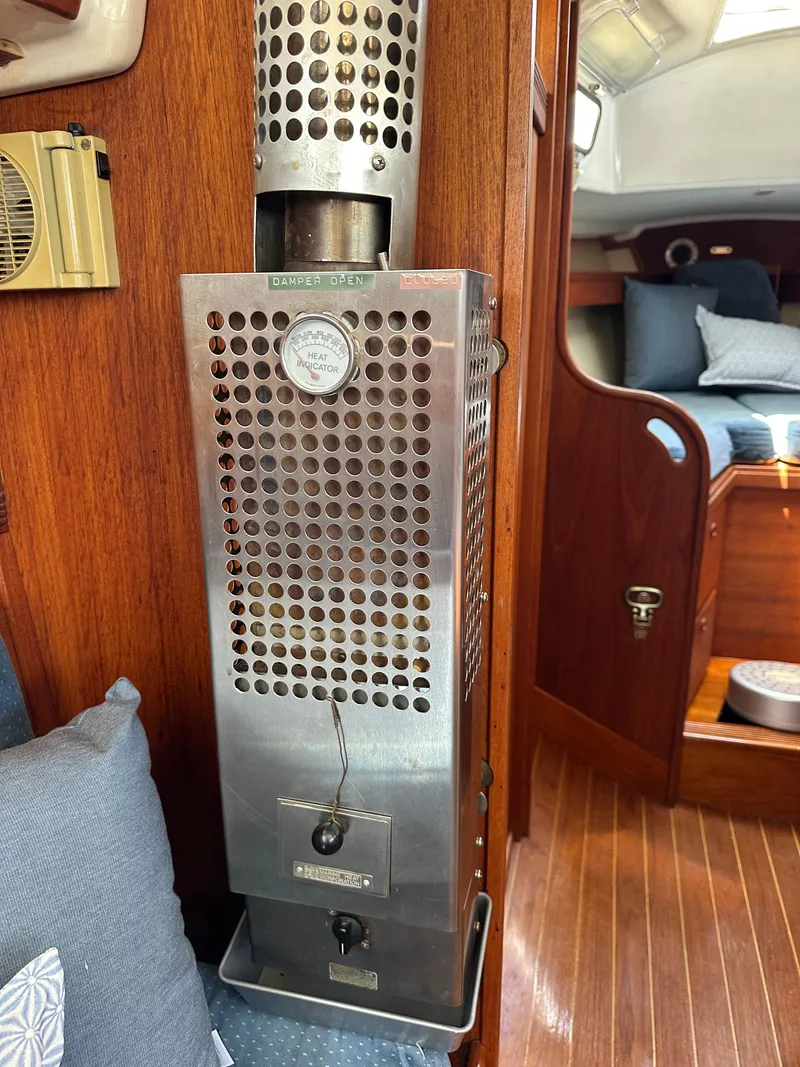 Slide: The Image of 1985 Sabre 34 MKI cabin interior with a stainless steel heater and wooden paneling. - 24