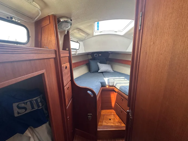 Slide: The Image of Cozy cabin interior of 1985 Sabre 34 MKI sailboat with wooden furnishings and bedding. - 25