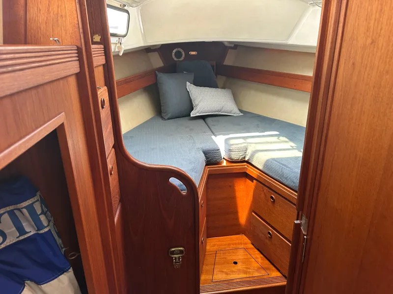 Slide: The Image of Cozy cabin interior of 1985 Sabre 34 MKI sailboat with wooden finish and blue bedding. - 26