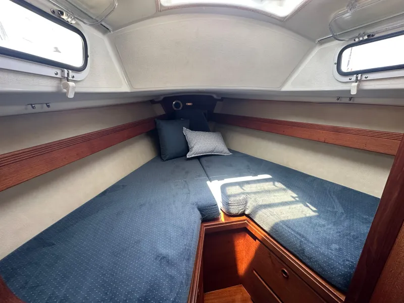 Slide: The Image of 1985 Sabre 34 MKI sailboat cabin with cozy V-berth and blue bedding. - 27