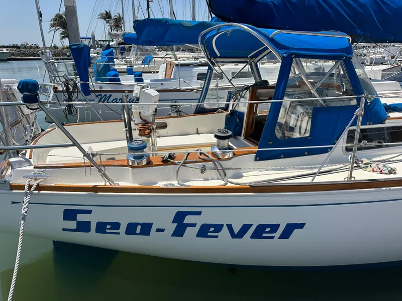 Slide: The Image of 1985 Sabre 34 MKI sailboat "Sea-Fever" docked in a marina with blue covers. - 3