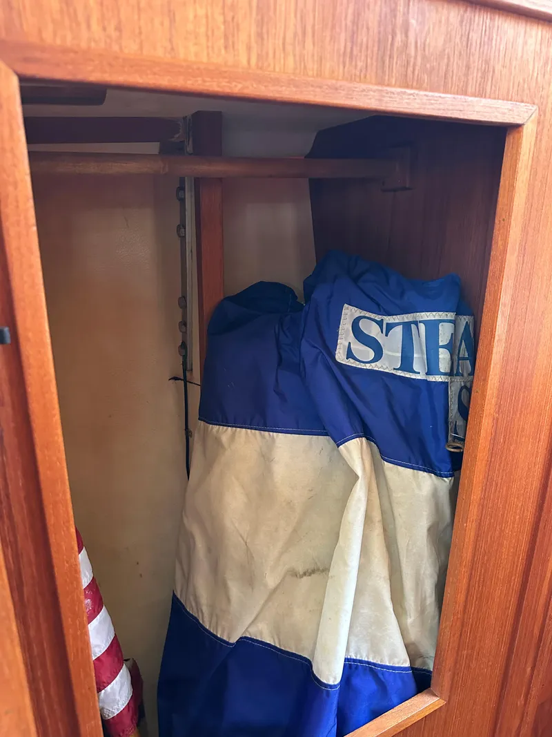 Slide: The Image of Wooden cabinet on 1985 Sabre 34 MKI sailboat with stored blue and white sail. - 31