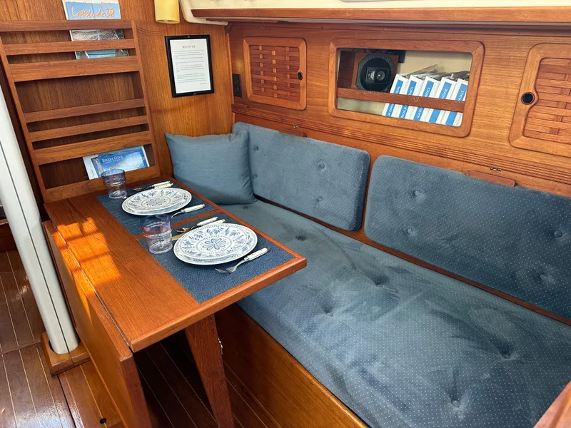 Slide: The Image of Cozy interior of 1985 Sabre 34 MKI sailboat with dining setup and blue cushions. - 37