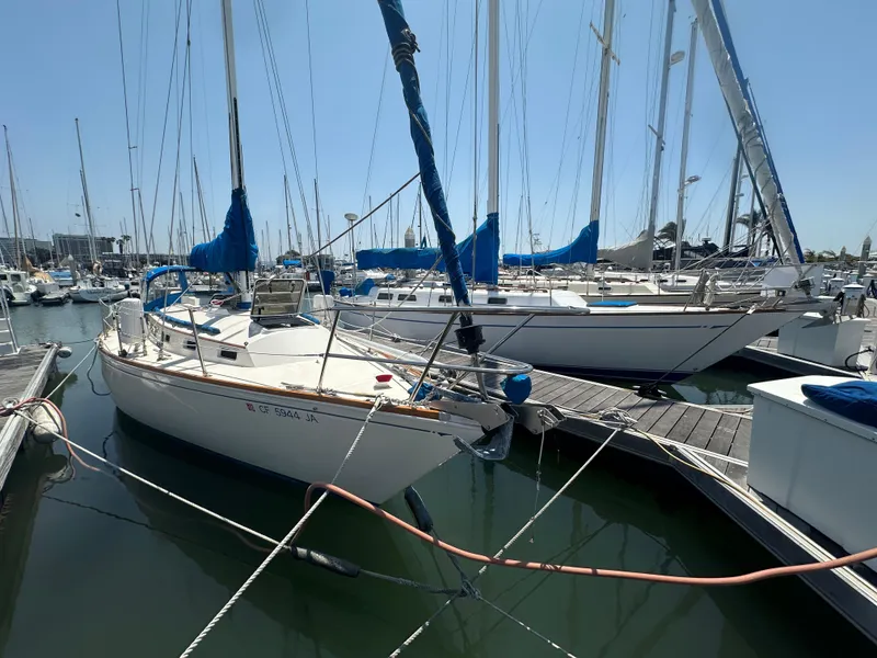 Slide: The Image of 1985 Sabre 34 MKI sailboat docked in marina, surrounded by other boats. - 4