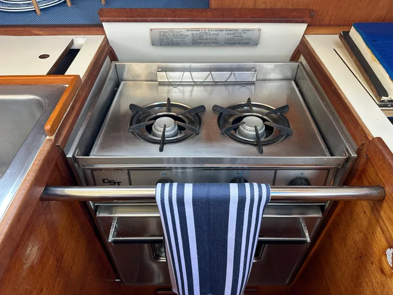 Slide: The Image of 1985 Sabre 34 MKI yacht kitchen with stainless steel stove and striped towel. - 40