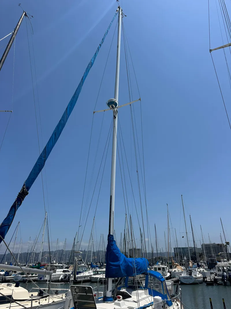 Slide: The Image of 1985 Sabre 34 MKI sailboat docked at marina under clear blue sky. - 46