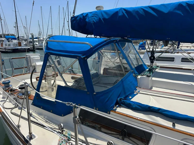 Slide: The Image of 1985 Sabre 34 MKI sailboat with blue canvas cover docked at marina. - 5
