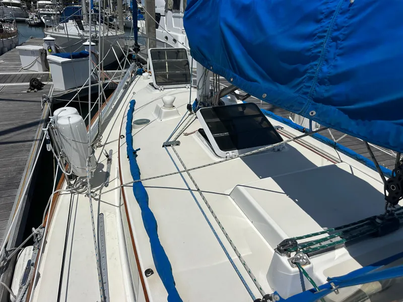 Slide: The Image of 1985 Sabre 34 MKI sailboat with blue cover docked at marina. - 7