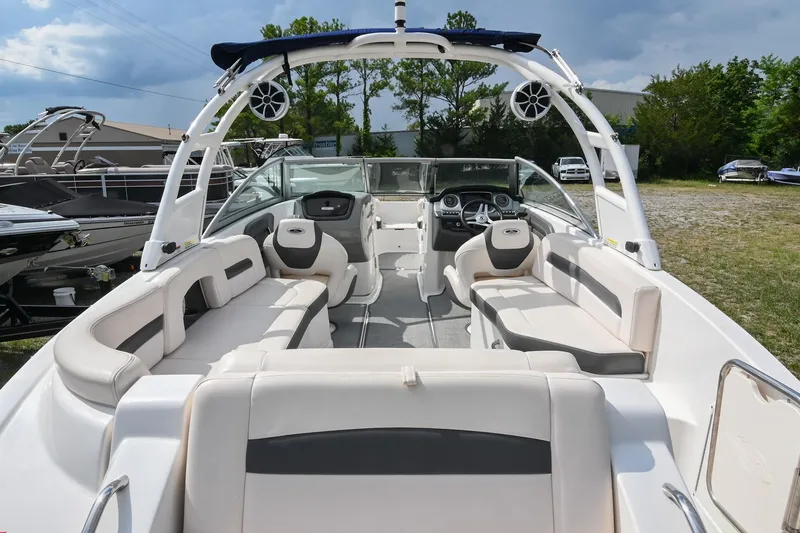 Slide: The Image of 2018 Chaparral 264 Sunesta boat interior with spacious seating and modern dashboard. - 11