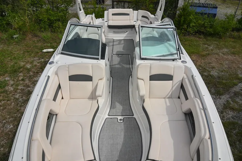 Slide: The Image of 2018 Chaparral 264 Sunesta boat interior with spacious seating and open deck layout. - 12