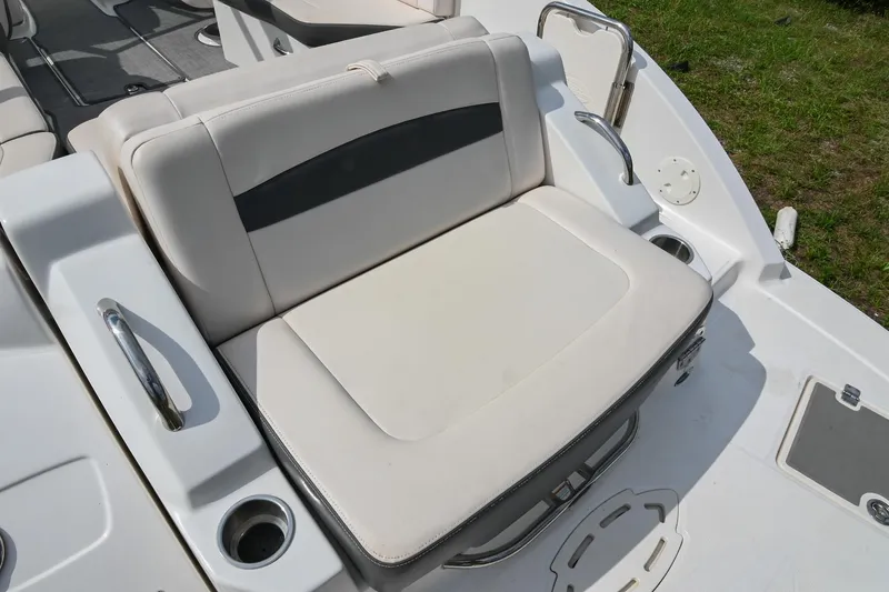 Slide: The Image of 2018 Chaparral 264 Sunesta boat seating area with cup holders and stainless steel handles. - 13