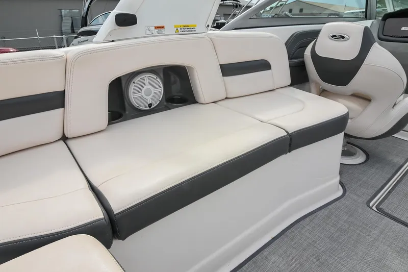 Slide: The Image of 2018 Chaparral 264 Sunesta boat interior with beige seating and speaker system. - 18