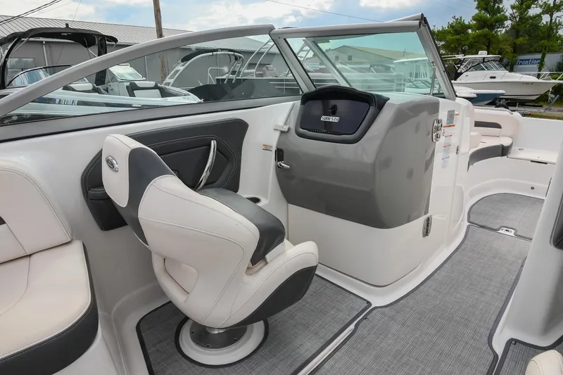 Slide: The Image of 2018 Chaparral 264 Sunesta boat interior with helm and seating area. - 21