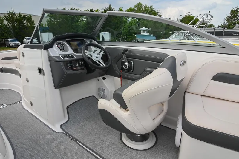 Slide: The Image of 2018 Chaparral 264 Sunesta boat interior with steering wheel and seating. - 24