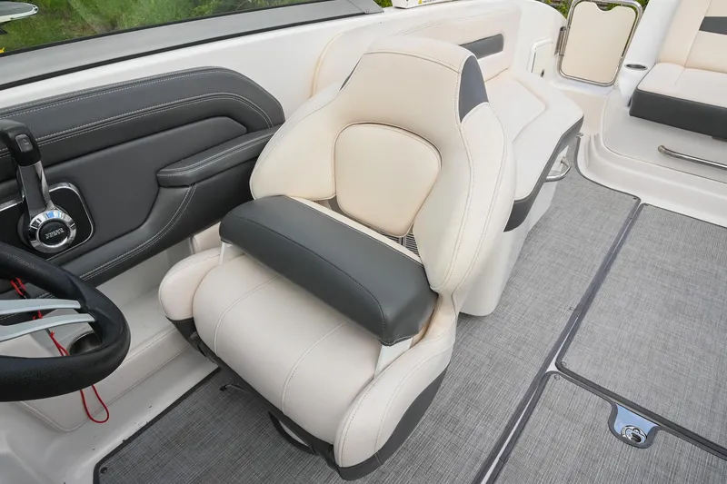 Slide: The Image of Captain's seat in 2018 Chaparral 264 Sunesta boat, featuring luxurious beige and black upholstery. - 27