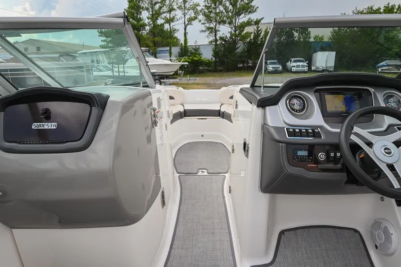 Slide: The Image of 2018 Chaparral 264 Sunesta boat interior with dashboard and seating area. - 28