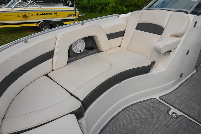 Slide: The Image of 2018 Chaparral 264 Sunesta boat interior with cushioned seating and speaker. - 33
