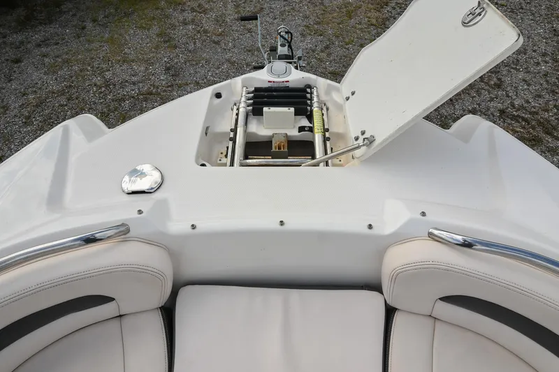Slide: The Image of 2018 Chaparral 264 Sunesta boat with open storage compartment and seating area. - 34