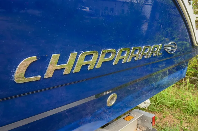 Slide: The Image of Close-up of 2018 Chaparral 264 Sunesta boat logo on blue hull. - 9