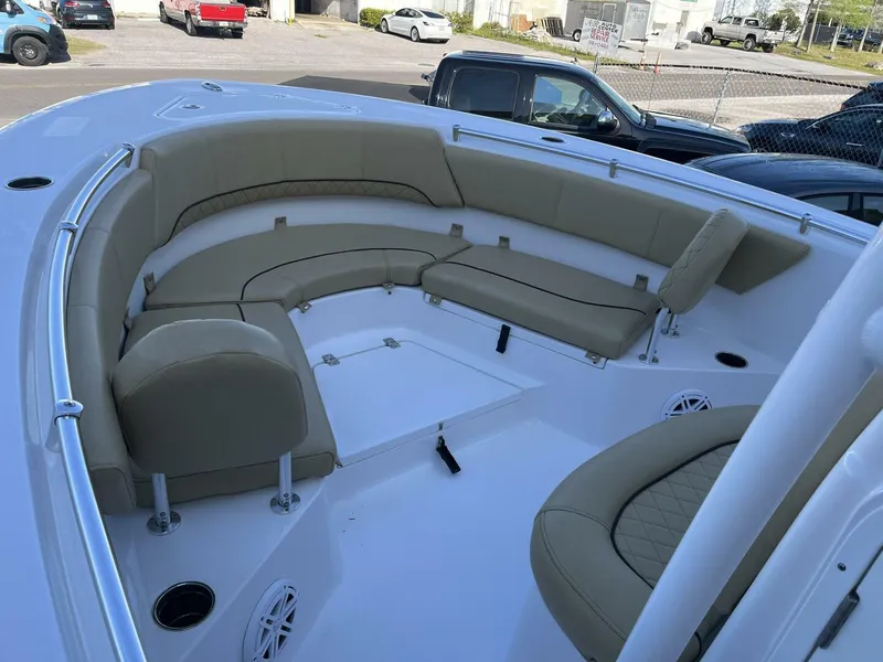 Slide: The Image of 2021 Sportsman 231 Heritage boat interior with beige seating and cup holders. - 10