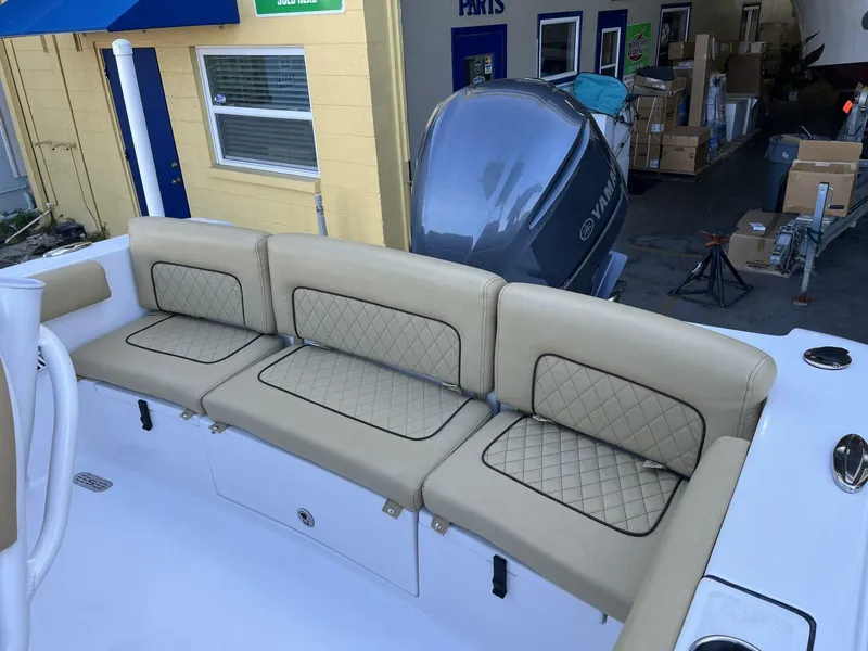 Slide: The Image of 2021 Sportsman 231 Heritage boat with beige cushioned seating and Yamaha engine. - 13