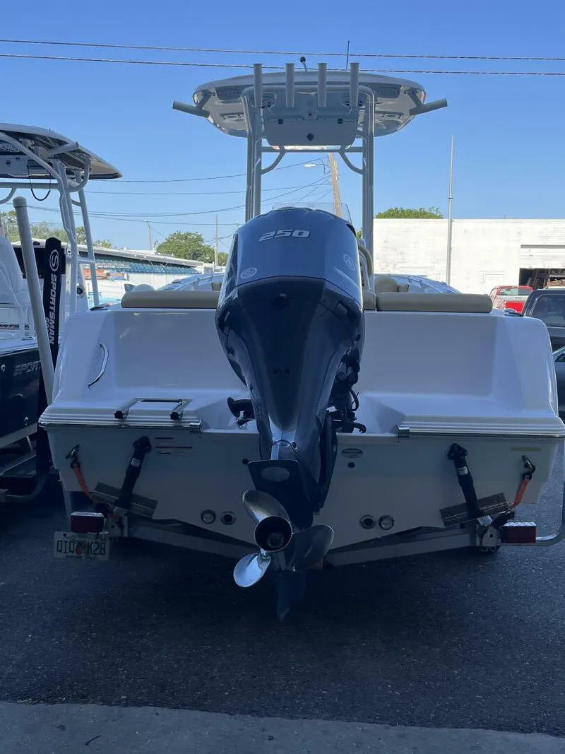 Slide: The Image of 2021 Sportsman 231 Heritage boat with powerful outboard motor, parked in a marina. - 3