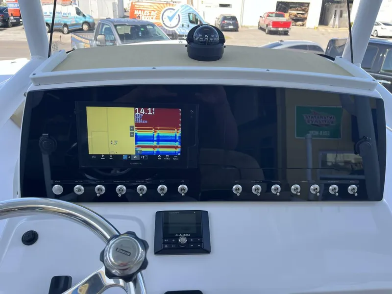 Slide: The Image of 2021 Sportsman 231 Heritage boat dashboard with navigation screen and controls. - 5