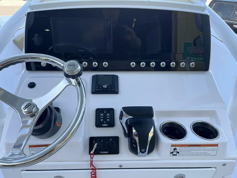 Slide: The Image of Dashboard of a 2021 Sportsman 231 Heritage boat with steering wheel and controls. - 6