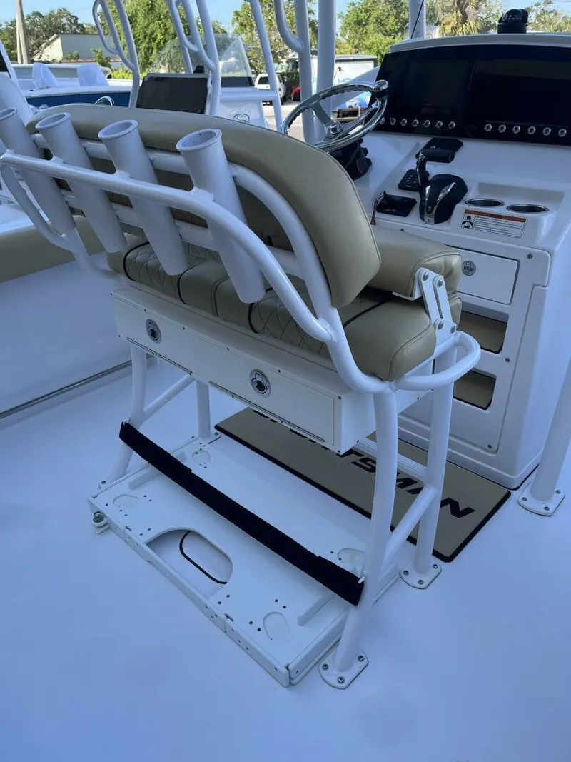Slide: The Image of 2021 Sportsman 231 Heritage boat interior with helm, rod holders, and seating. - 7
