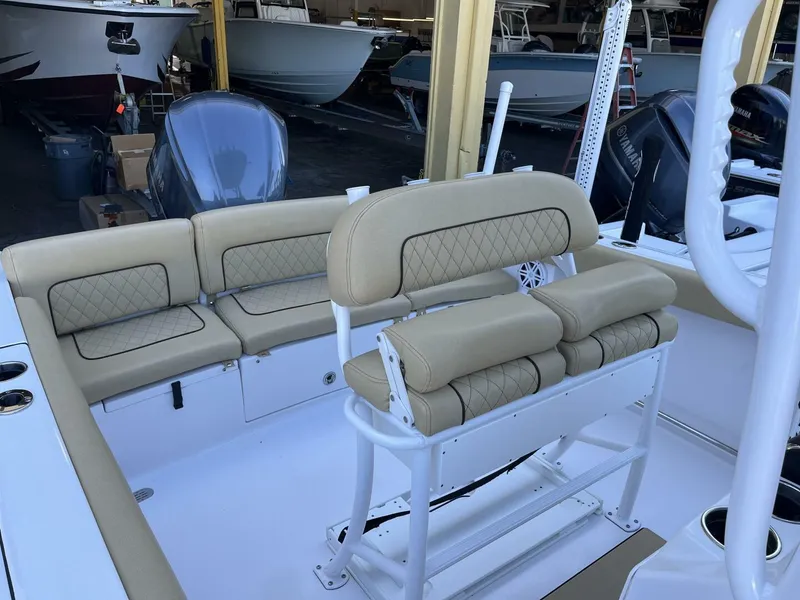 Slide: The Image of 2021 Sportsman 231 Heritage boat interior with beige cushioned seating and dual outboard motors. - 8