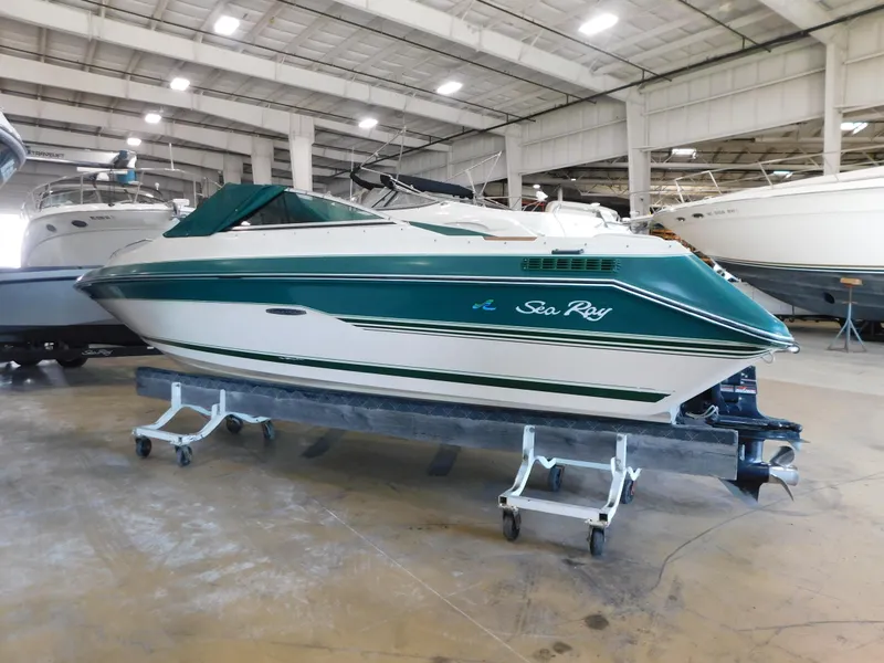 Slide: The Image of 1989 Sea Ray 20 Cuddy boat in indoor storage, green and white design. - 3