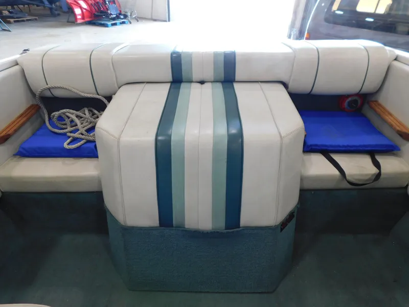 Slide: The Image of 1989 Sea Ray 20 CUDDY interior with blue and white seating, rope, and cushions. - 4
