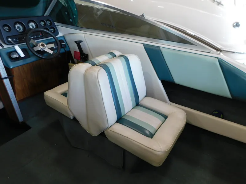 Slide: The Image of 1989 Sea Ray 20 CUDDY boat interior with striped seats and dashboard. - 5