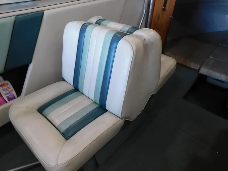 Slide: The Image of 1989 Sea Ray 20 CUDDY interior with striped upholstery and cabin view. - 6