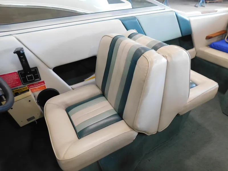 Slide: The Image of 1989 Sea Ray 20 CUDDY interior with striped seats and control panel. - 8