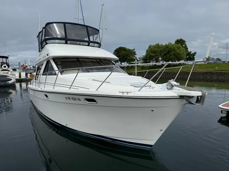 Slide: The Image of 2001 Bayliner 3988 Command Bridge Motoryacht docked in a marina, overcast sky. - 10