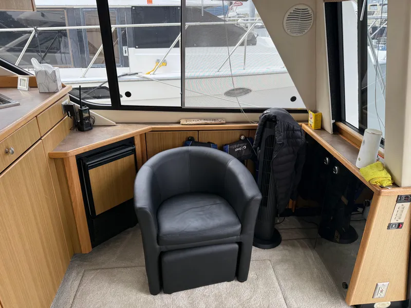 Slide: The Image of Interior of 2001 Bayliner 3988 Command Bridge Motoryacht with black chair and wooden cabinetry. - 14
