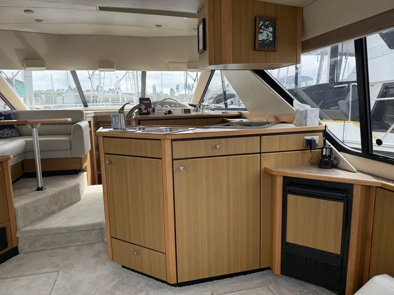Slide: The Image of Interior of 2001 Bayliner 3988 Command Bridge Motoryacht with modern kitchen and seating area. - 15