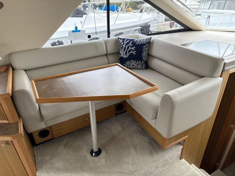 Slide: The Image of Interior of 2001 Bayliner 3988 Command Bridge Motoryacht with cushioned seating and table. - 16