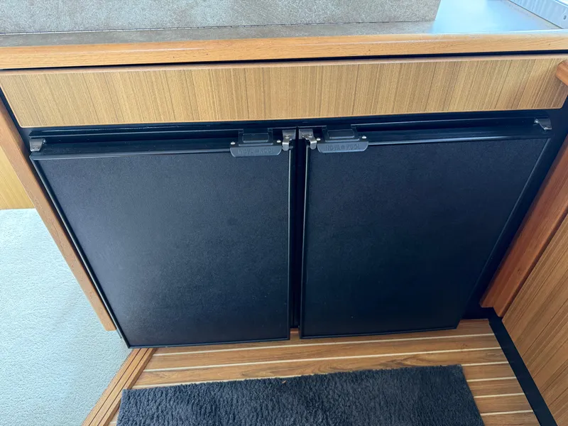 Slide: The Image of 2001 Bayliner 3988 Command Bridge Motoryacht interior with dual black fridge doors. - 20