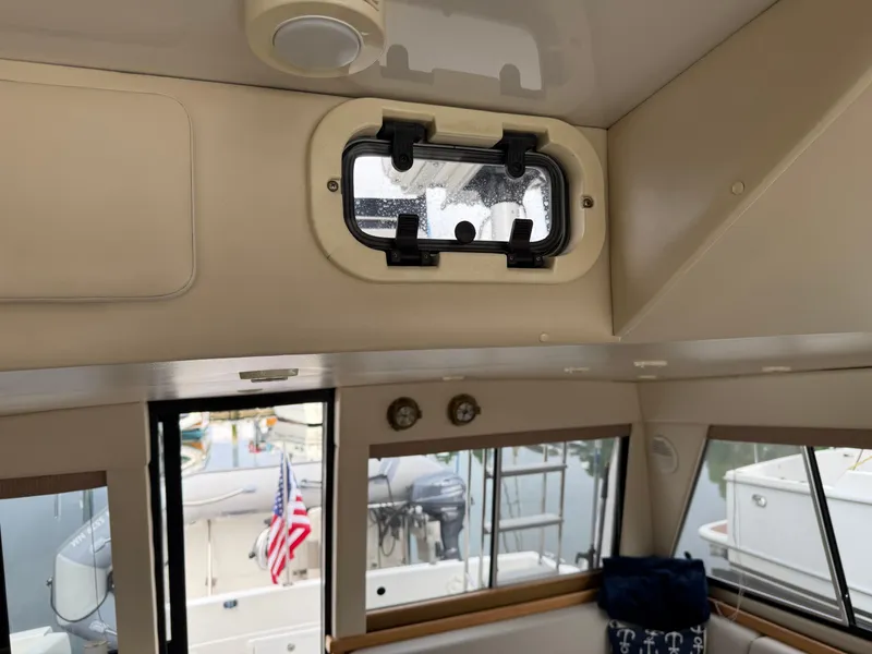 Slide: The Image of Interior view of 2001 Bayliner 3988 Command Bridge Motoryacht with windows and American flag. - 23