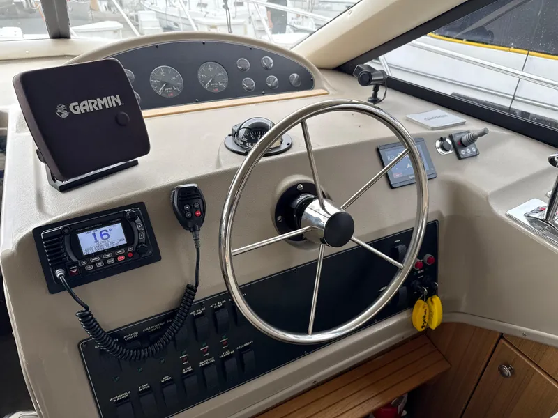 Slide: The Image of 2001 Bayliner 3988 Command Bridge Motoryacht helm with Garmin navigation and control panel. - 26