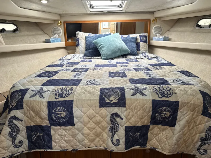 Slide: The Image of Cozy bedroom in 2001 Bayliner 3988 Command Bridge Motoryacht with nautical-themed bedding. - 28